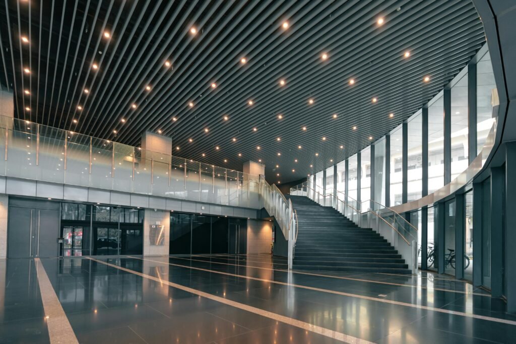 Elegant corporate hall featuring a curved staircase and sleek interior design.
